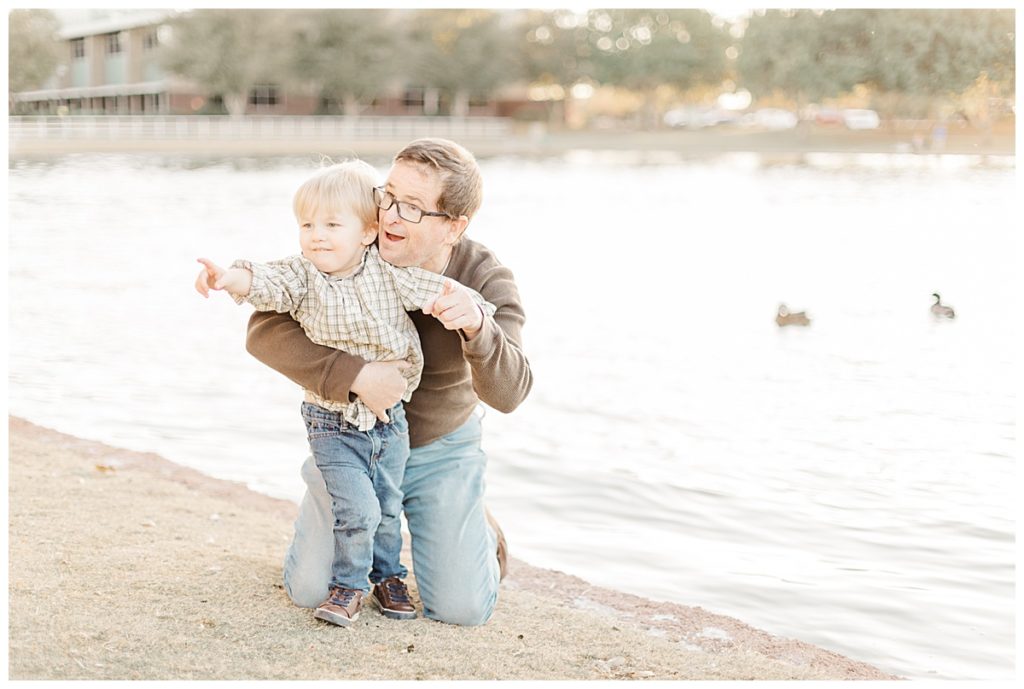 Dad playing with little boy near a duck pond at Morrison Ranch