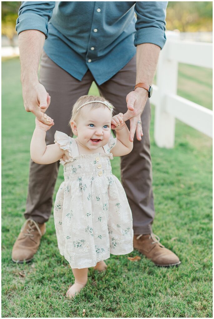 1 Year Old Photos at Morrison Ranch, little girl holding dads hands and walking