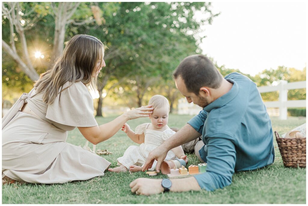 Morrison Ranch Family Photos ... mom & dad playing on the grass with 1-year-old girl