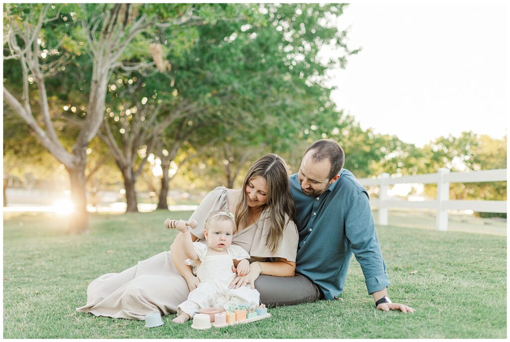 Morrison Ranch Family Photos ... mom & dad playing on the grass with 1-year-old girl