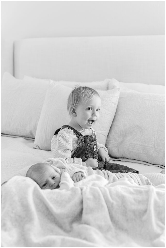 toddler meeting her newborn little brother