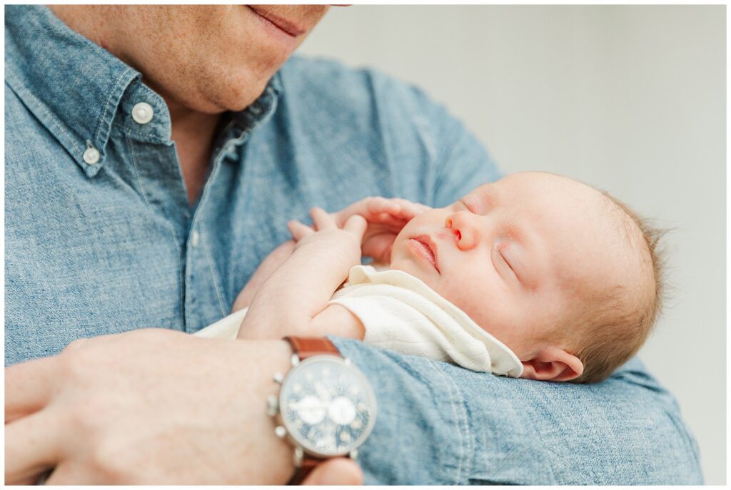 Dad holding newborn little girl