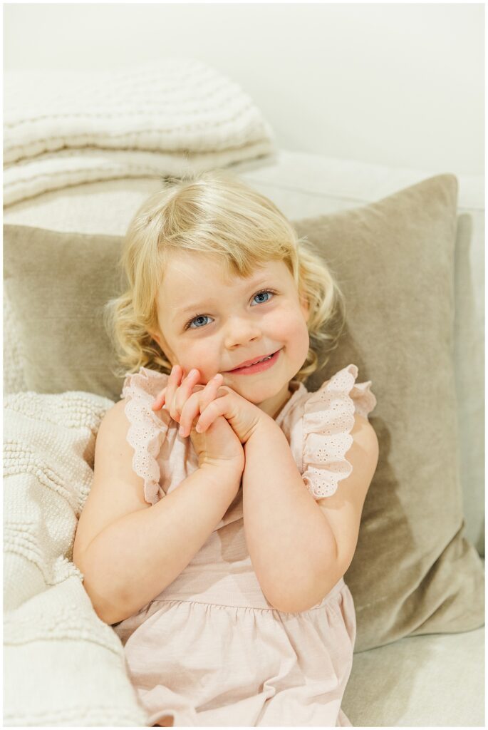 3 year old girl cozy on the couch