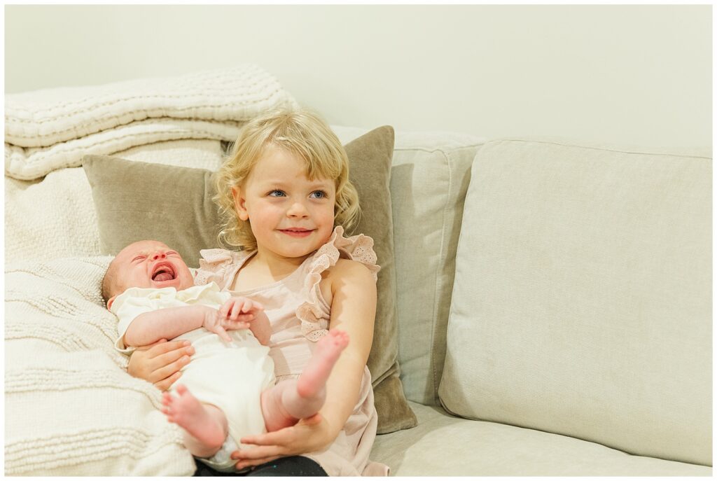 3 year old little girl holding her baby sister | Scottsdale lifestyle family photos