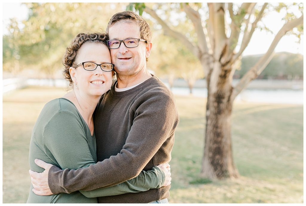 Couples photos at Morrison Ranch, standing on green grass and under big trees near a lake