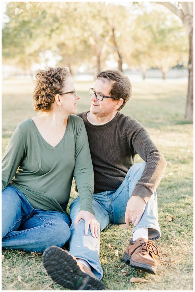 Couples Photos at Morrison Ranch sitting on green grass under big green trees