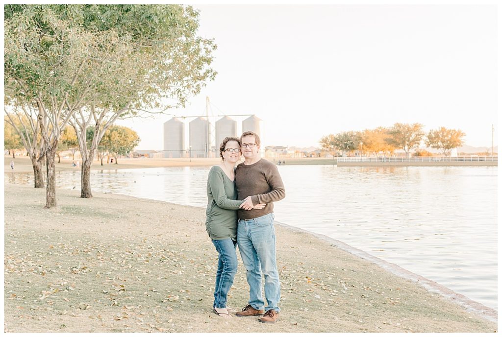 Couples photos at Morrison Ranch, standing in front of the four silos and a lake