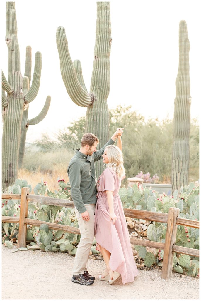 Couple dancing in front of cati at the riparian preserve, women is wearing a long flow dress. recipes for styling your engagement session