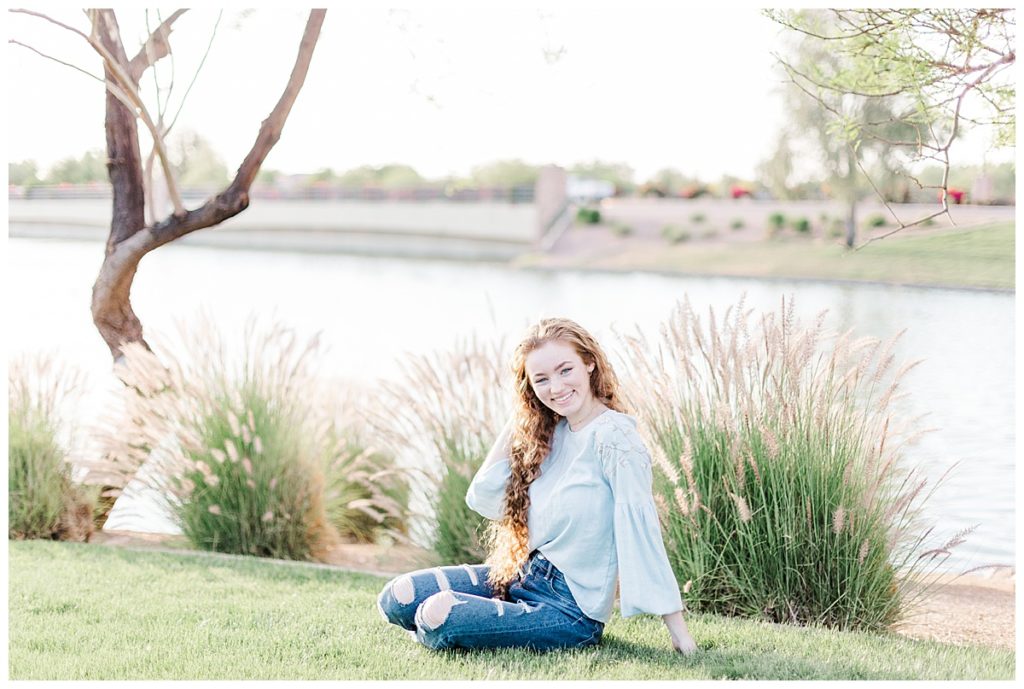 Senior photos, girl sitting on grass at Layton Lakes