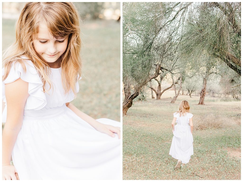 Little girl in a white dress running through a field of grass and trees at coons bluff