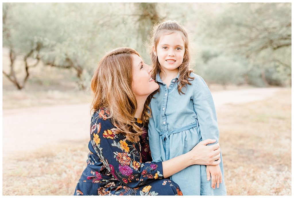 mom smiling toward little girl | family photos at Coons Bluff