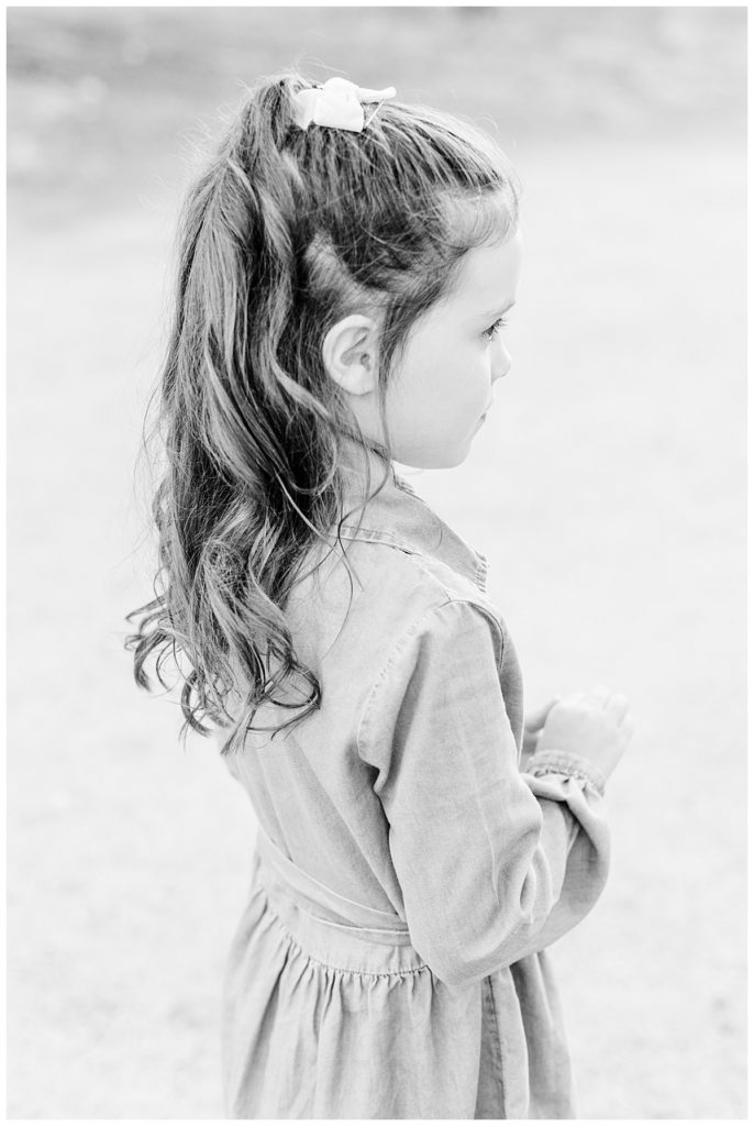 Little girl with long curled hair and a bow 