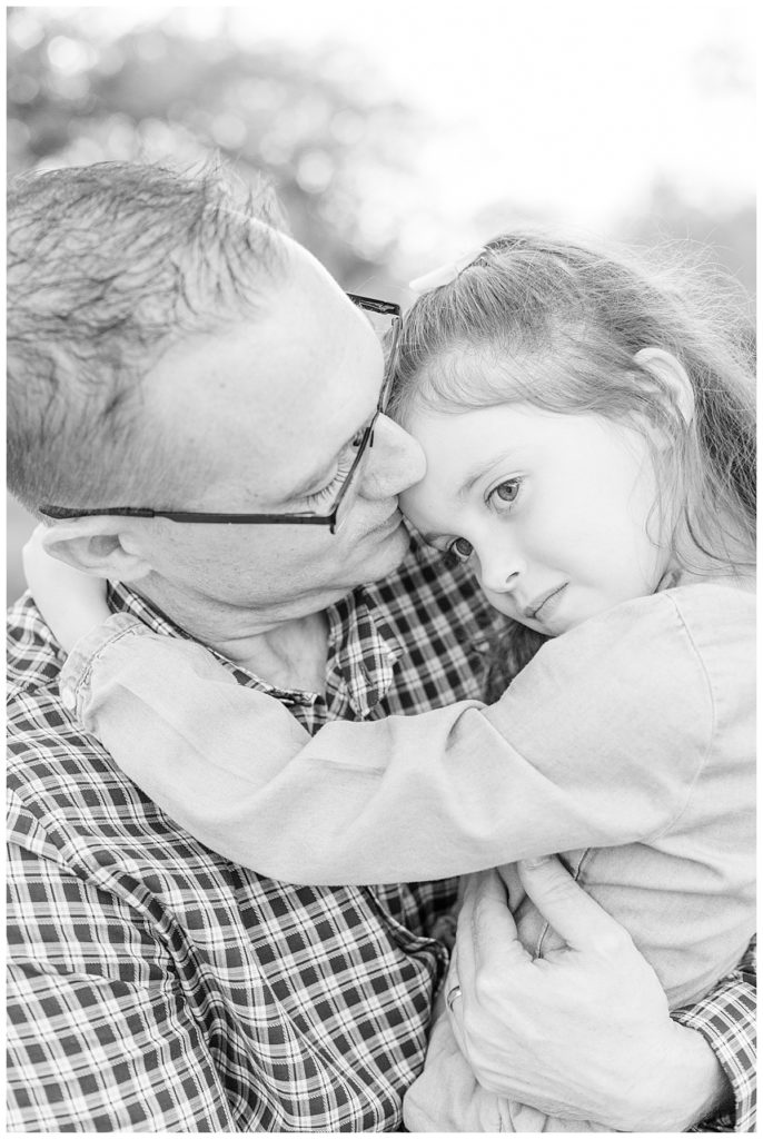 black and white photo of a Dad and daughter snuggling