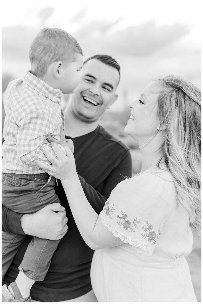 black and white of mom and dad laughing with little boy | Sanchez Family Photos at Coons Bluff | Arizona Desert Maternity Session