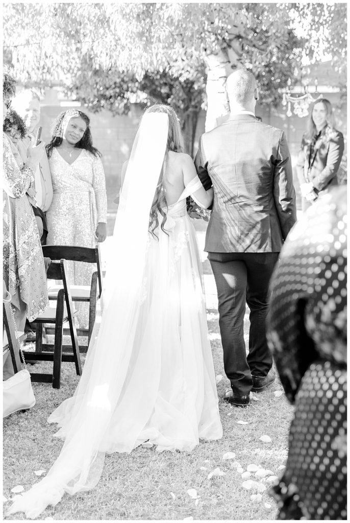 Black and White of Bride walking down the aisle with her brother |Private Estate Scottsdale Wedding Ceremony