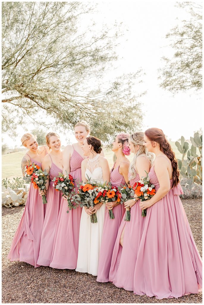 bride with her bridesmaids wearing pink dresses