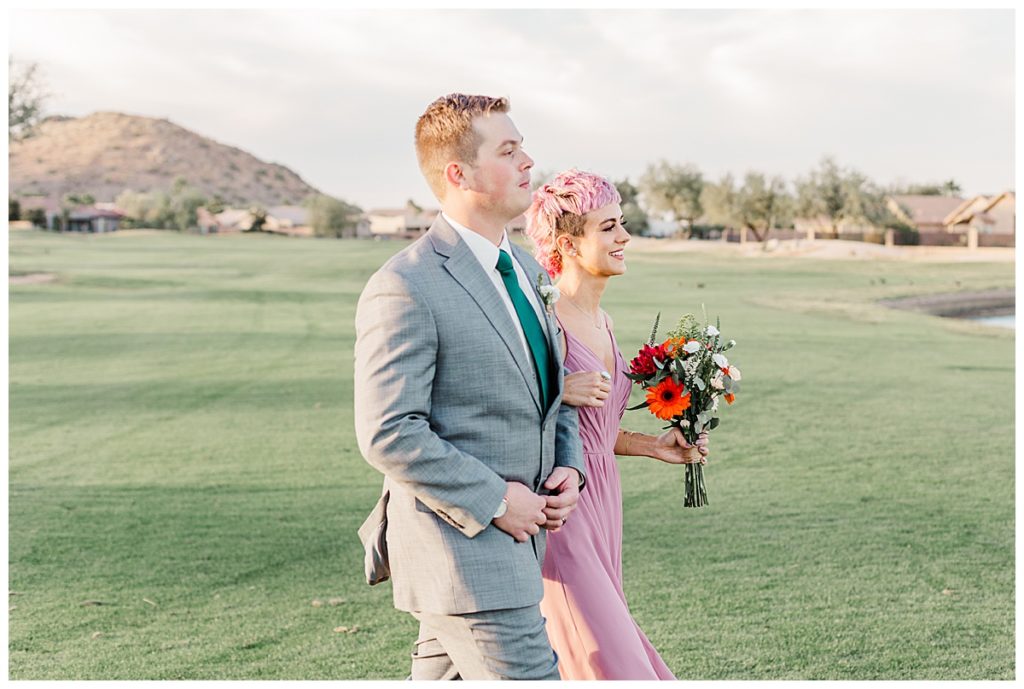 Maid of Honor and Best Man walking down the isle at Natalie and Steven's Wedding Ceremony at the Golf Club at Johnson Ranch Wedding | Gilbert, Arizona