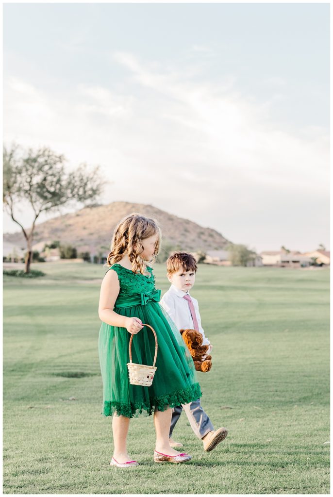 Flower girl and ring bearer walking down the isle at Natalie & Steven's Wedding Ceremony at the Golf Club at Johnson Ranch Wedding | Gilbert, Arizona